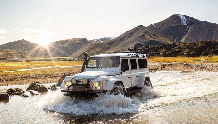 super jeep crossing a shallow river in landmannalaugar