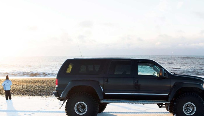 black super jeep in black sand beach in iceland
