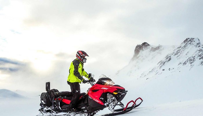driving a snowmobile on langjokull in iceland