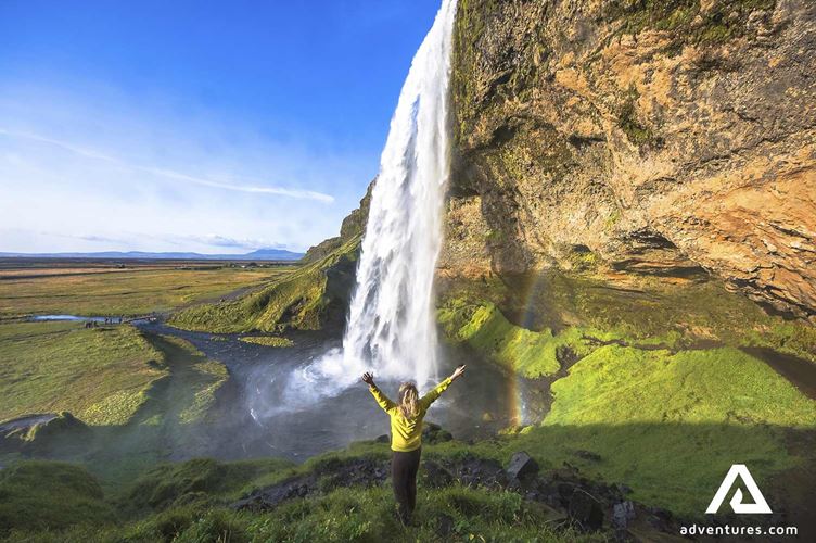 happy woman near seljalandsfoss happy woman near seljalandsfoss waterfall
