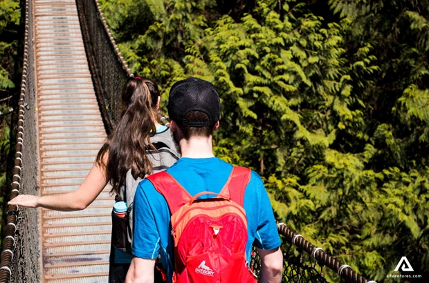 couple walking on a suspension bridge in canada
