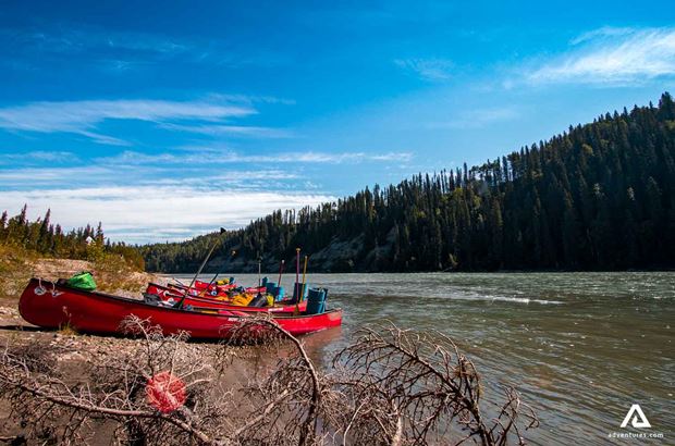 canoes lined up near a river canoes lined up near a river in canada