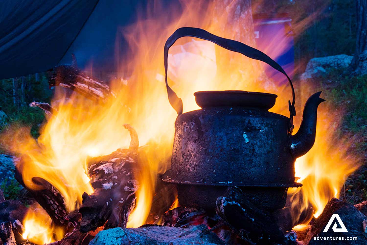 kettle on a campfire boiling water