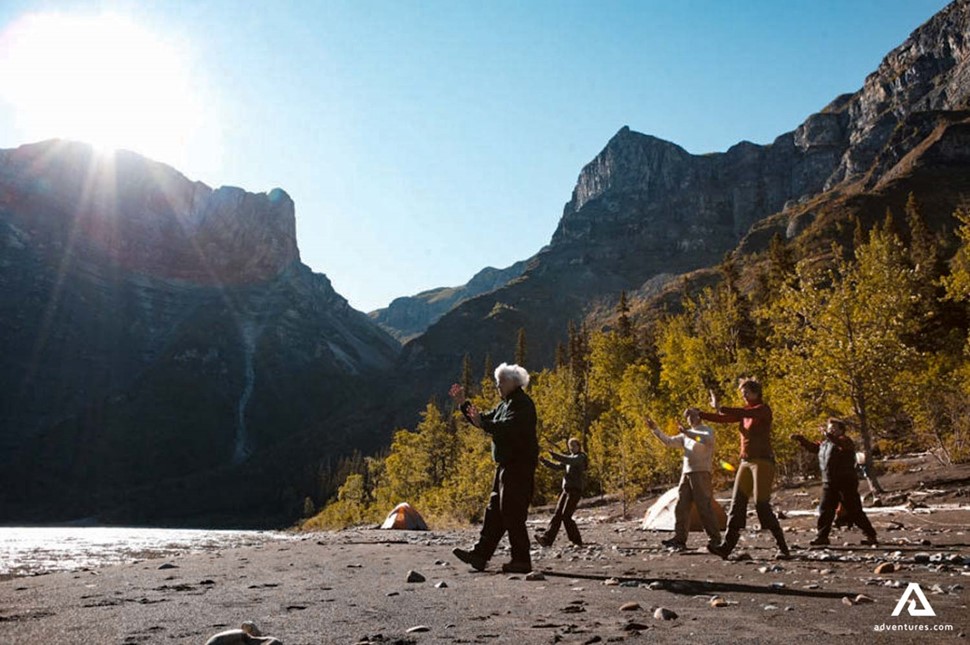 group walking near nahanni river on a sunny day