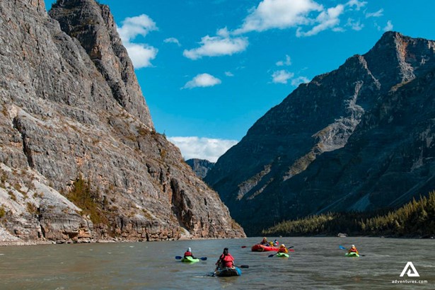 canoeing in nahanni river between mountains