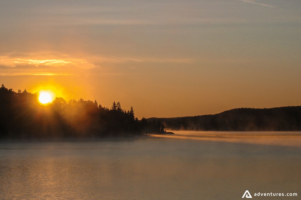 sunset over a misty lake in canada