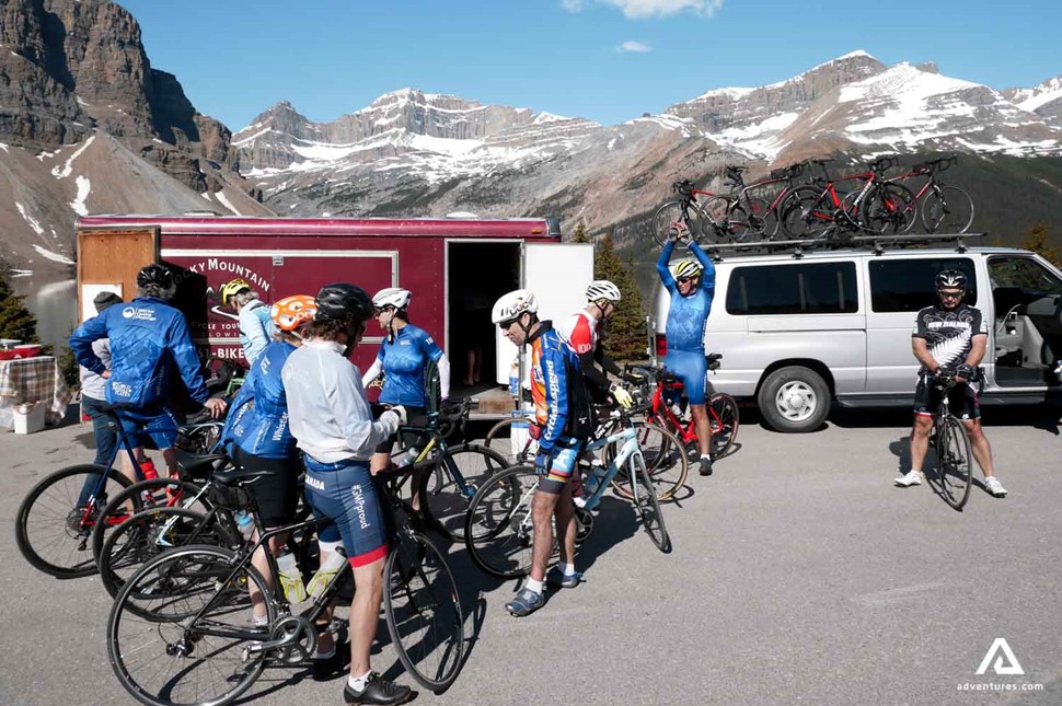 group of cyclists near a minibus getting ready