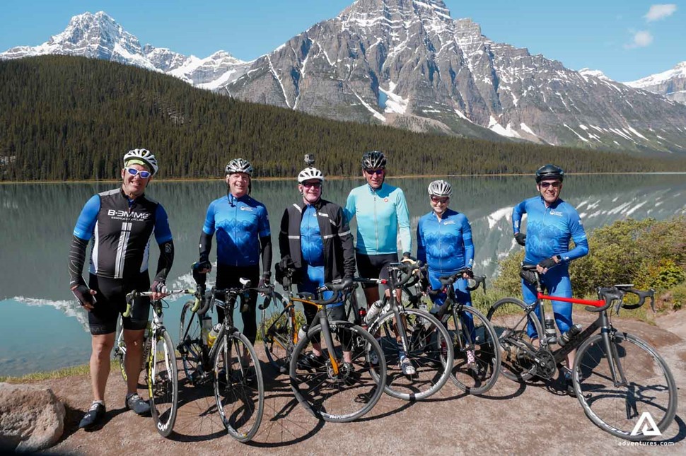 group of cyclists posing for a picture with their bikes