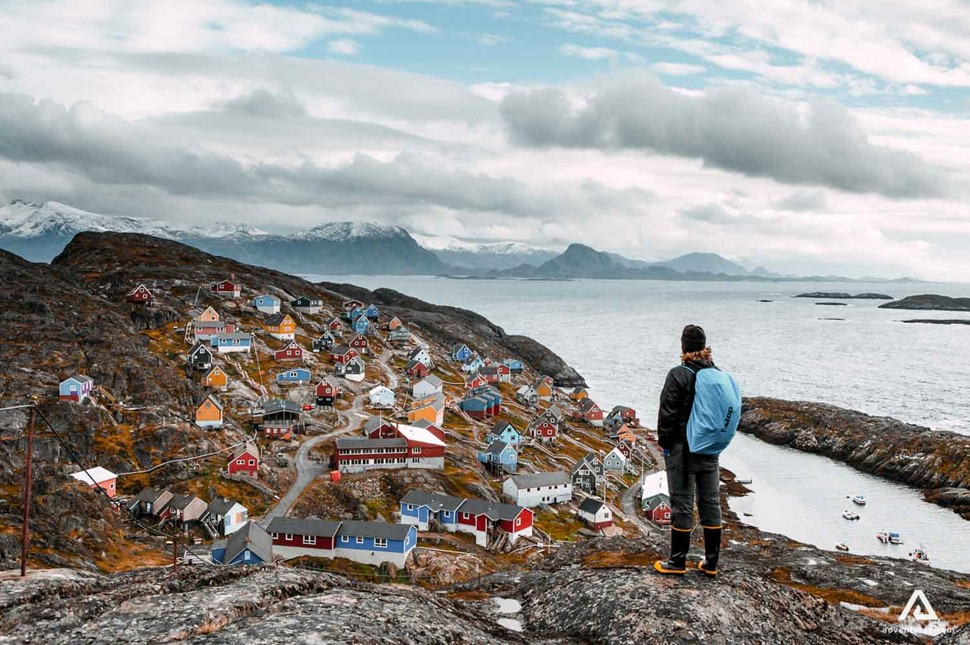 hiker in a colorful town in greenland
