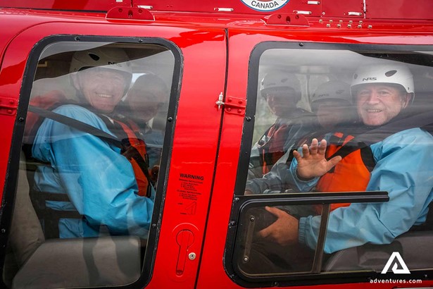 people in a helicopter before the tour