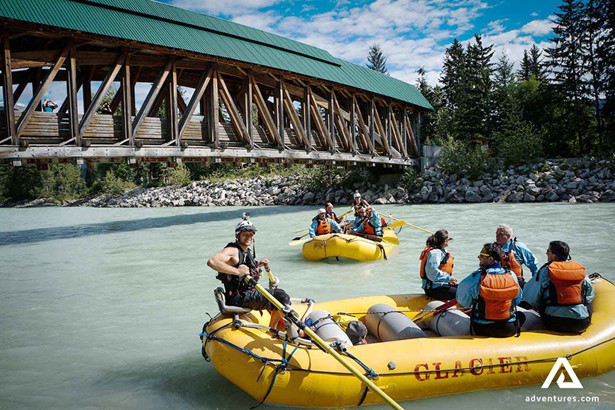 rafting under a bridge on a sunny day