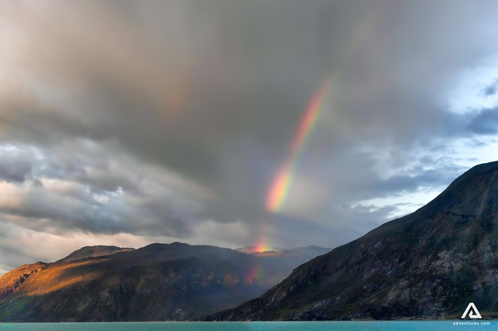 rainbow above a mountain range in greenland