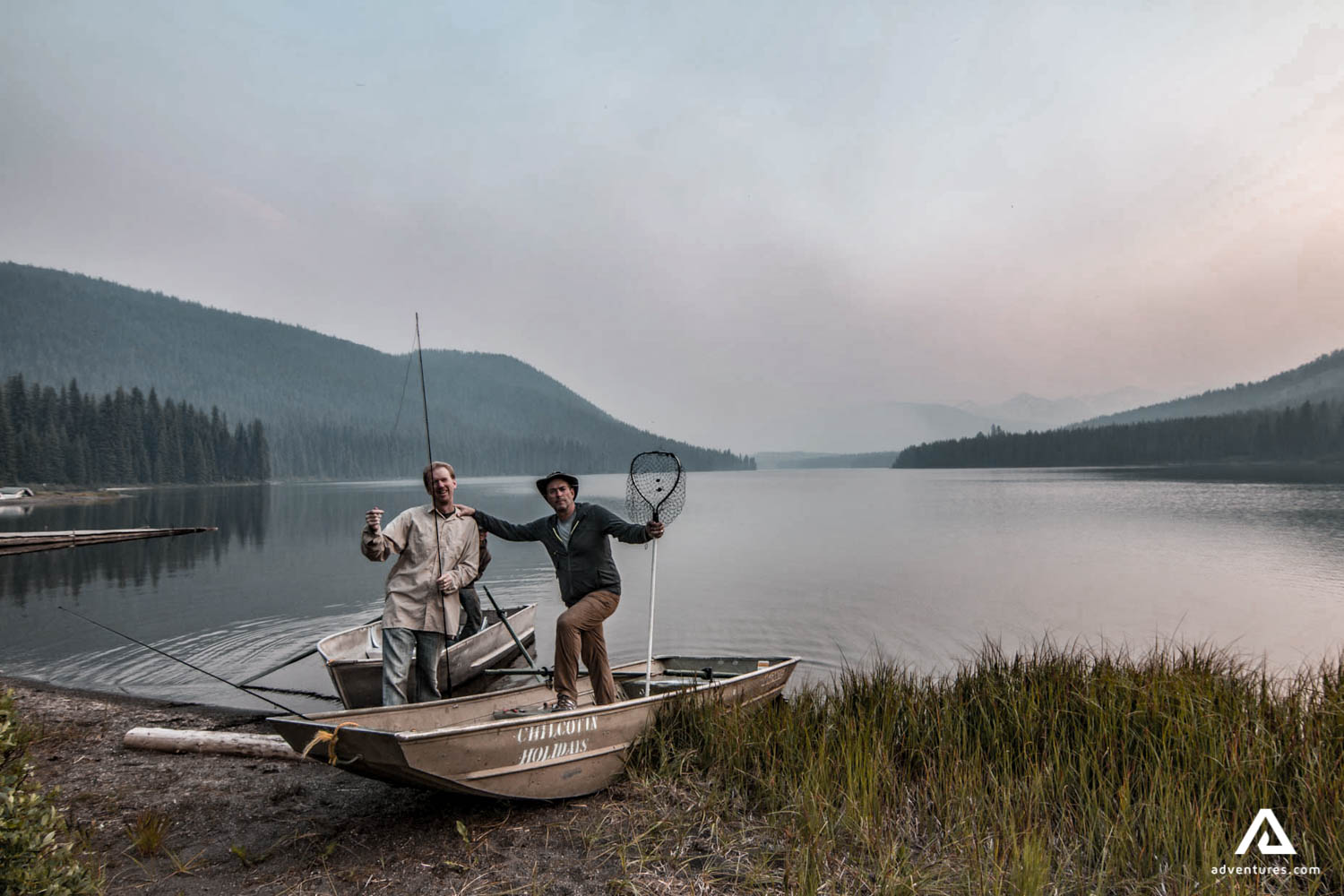 two people getting ready to fish at sunrise