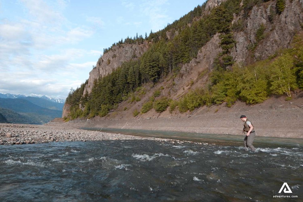 fly fishing in a river in canada at summer