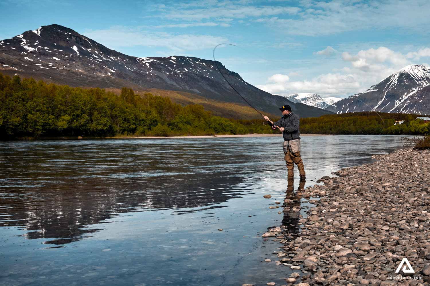 man fly fishing in canada at summer