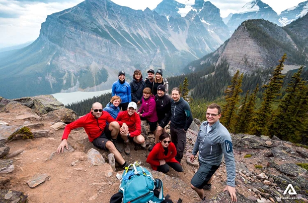 group posing at a mountain top in banff