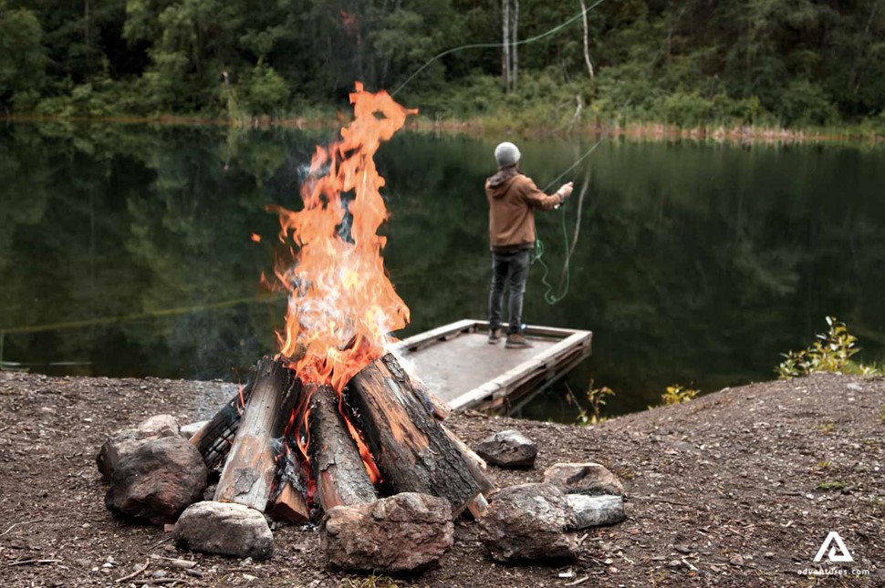 fly fishing near a campfire in canada