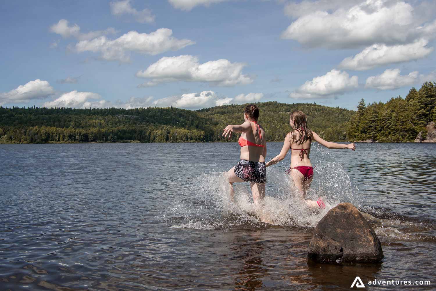 girls running into a lake