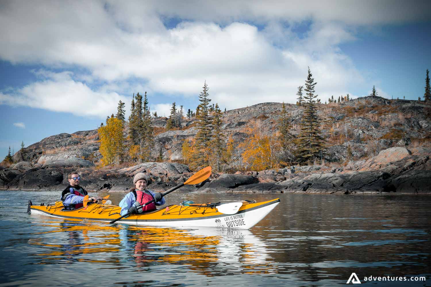 happy couple in a kayak in canada near seaside
