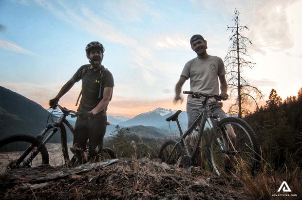 two men with mtbs two men with mtbs at sunset