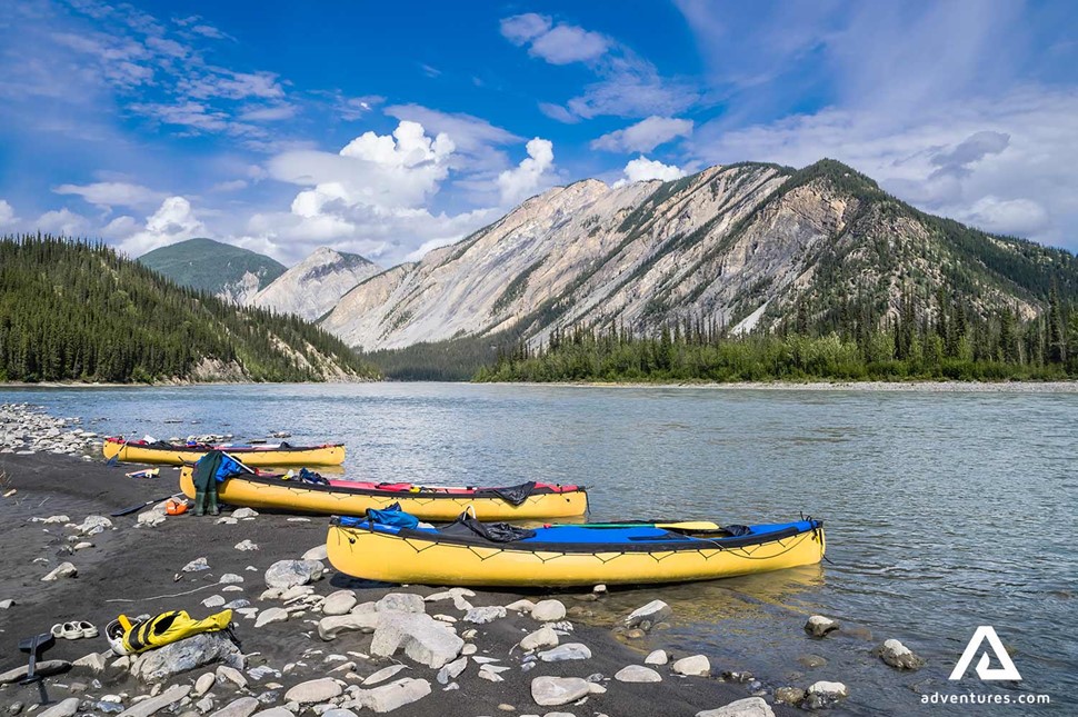kayaks on the shore of nahanni river in canada