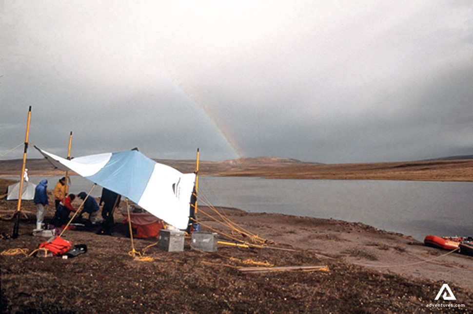 small campsite set up near a river in nunavut