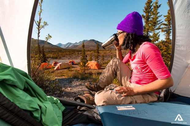 woman having coffee woman having coffee in a tent