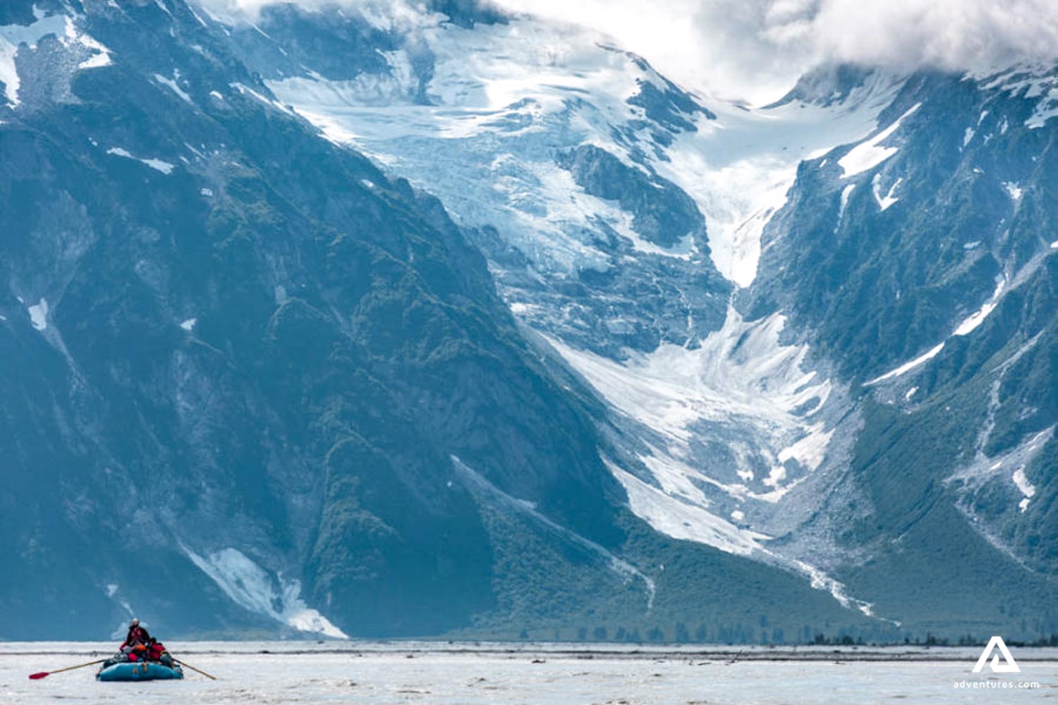 group rafting near a mountain range in canada