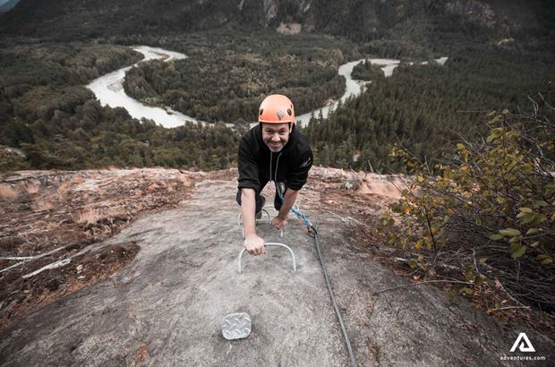 smiling man mountaineering smiling man mountaineering up a mountain