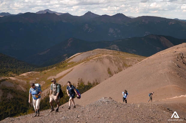 group if hikers on a mountain ridge in summer