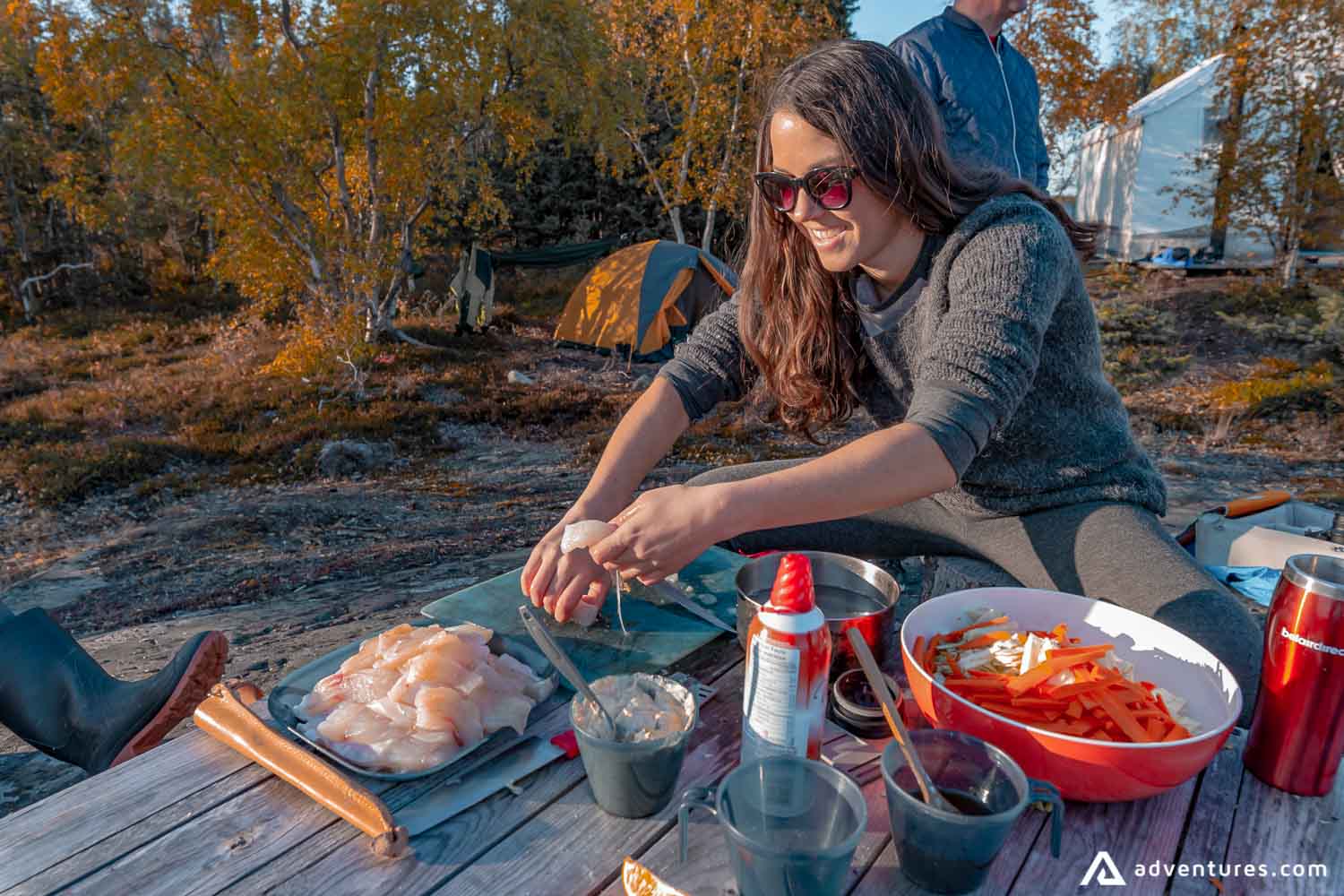 Woman preparing fish in nature