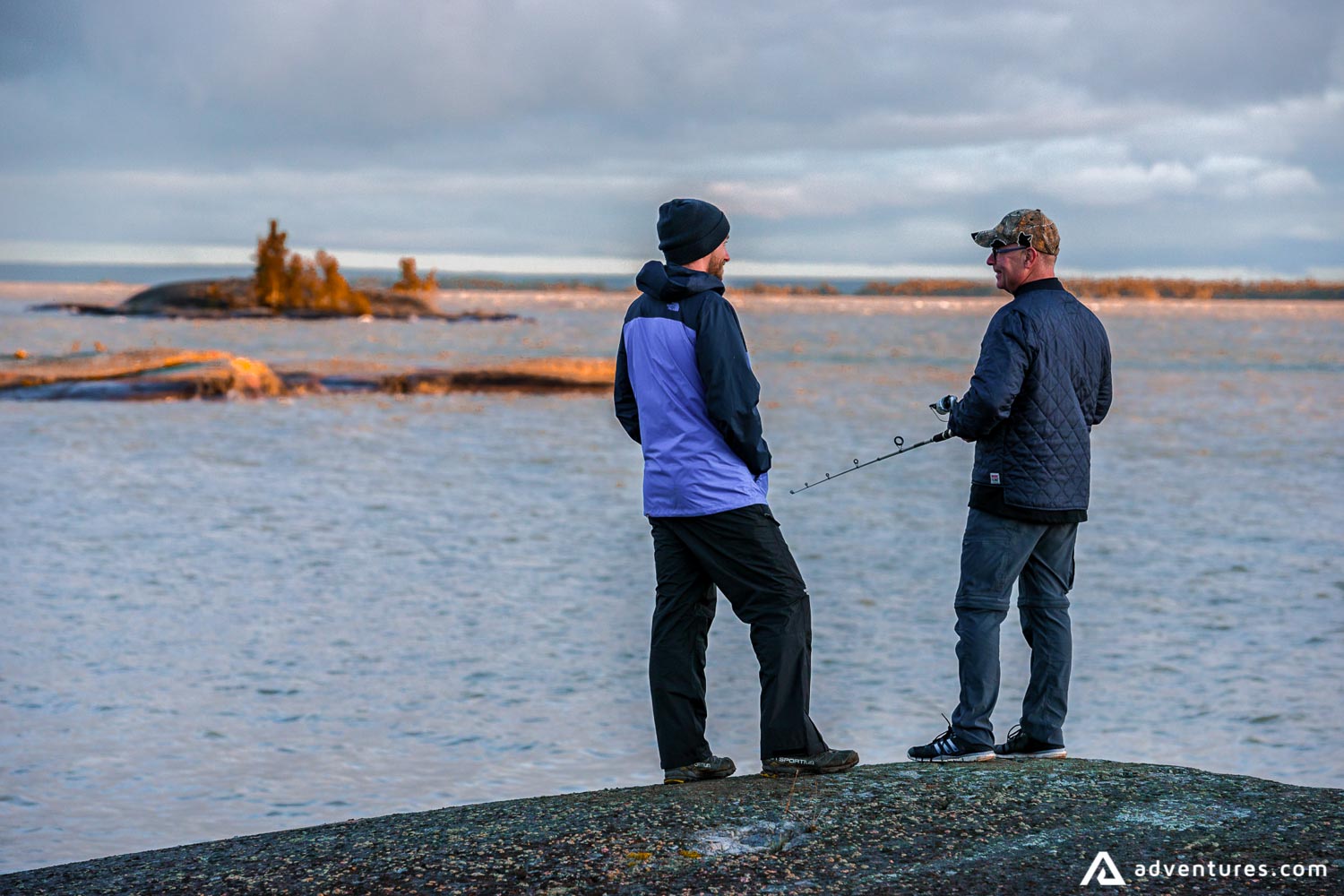 Men fishing on the shore of a lake