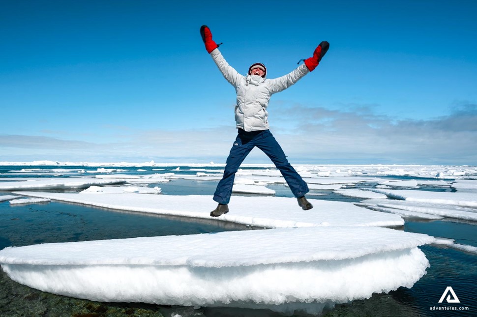 happy man jumping on ice in somerset island
