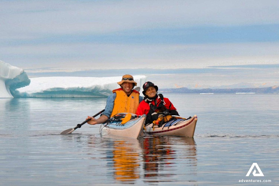 couple kayaking in baffin island in canada