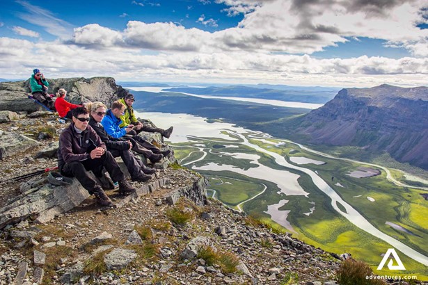 group resting on the top of mount skierfe in sweden