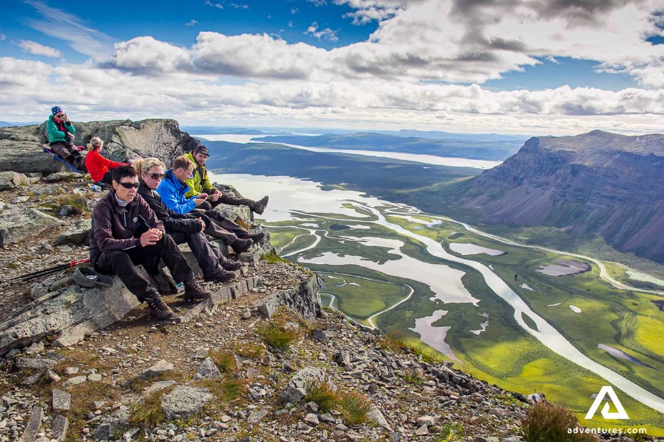 group resting on the top of mount skierfe in sweden