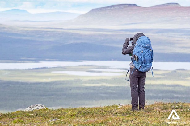 backpacker looking over sarek national park in sweden