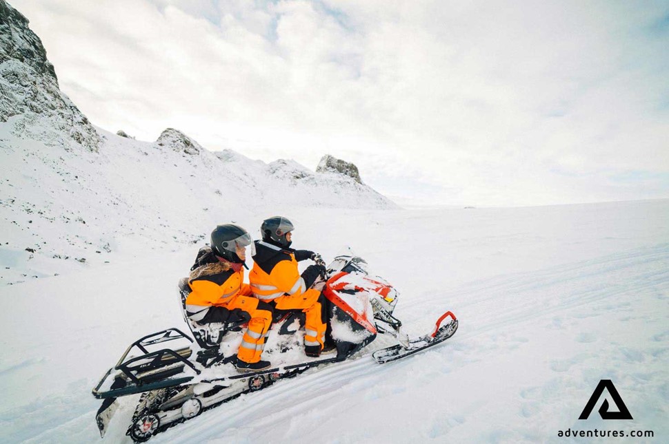 snowmobiling on langjokull glacier in winter with a friend