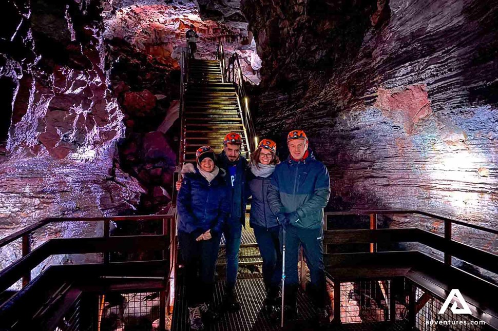 group of friends posing at lava tunnel in reykjanes peninsula