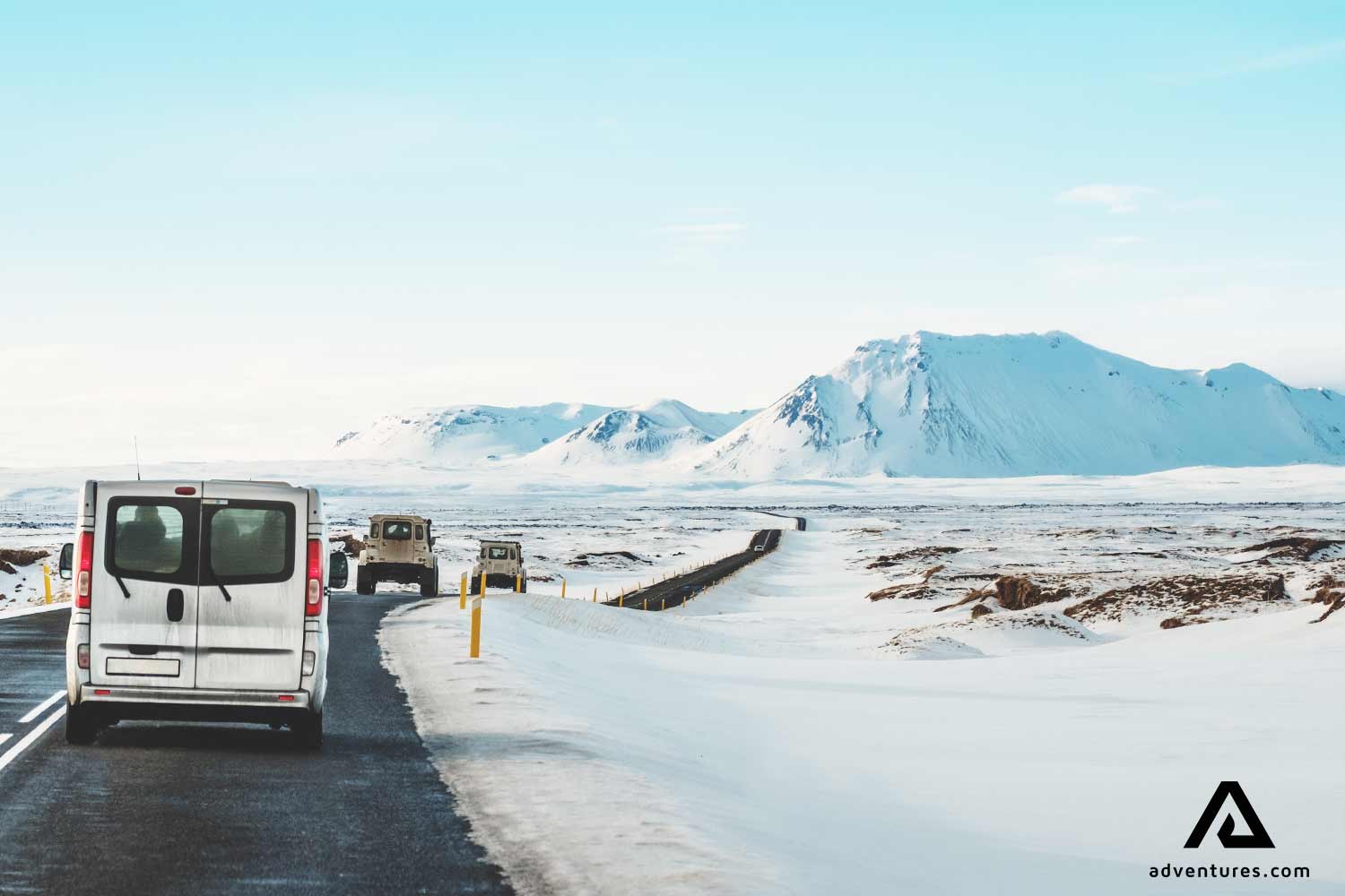 cars driving on a snowy road in iceland