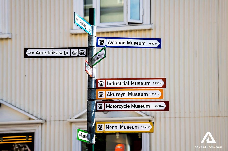 street sign with museums in akureyri in iceland