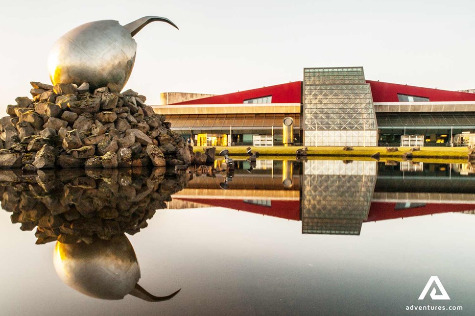 a steel statue near keflavik airport building