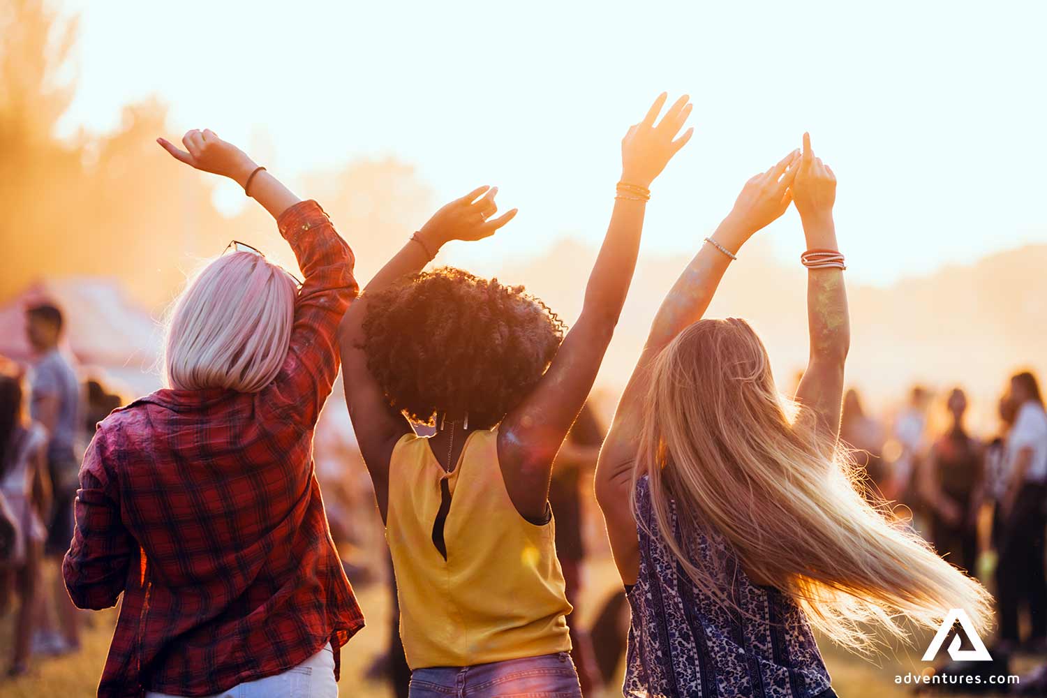 group of friends dancing in a music festival
