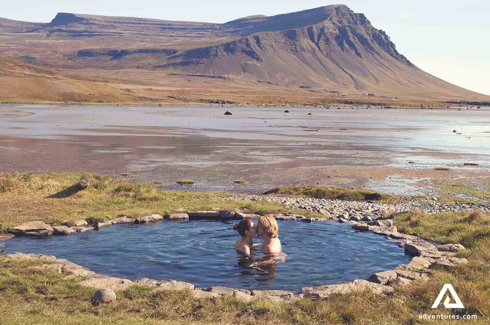 couple bathing in a hot spring in iceland