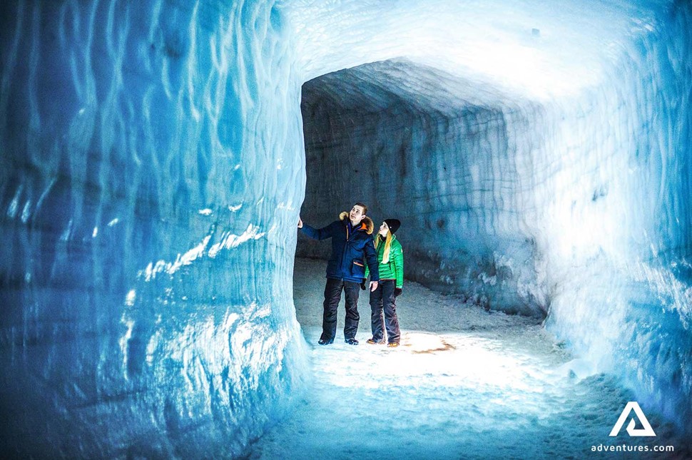 couple exploring into the glacier on langjokull