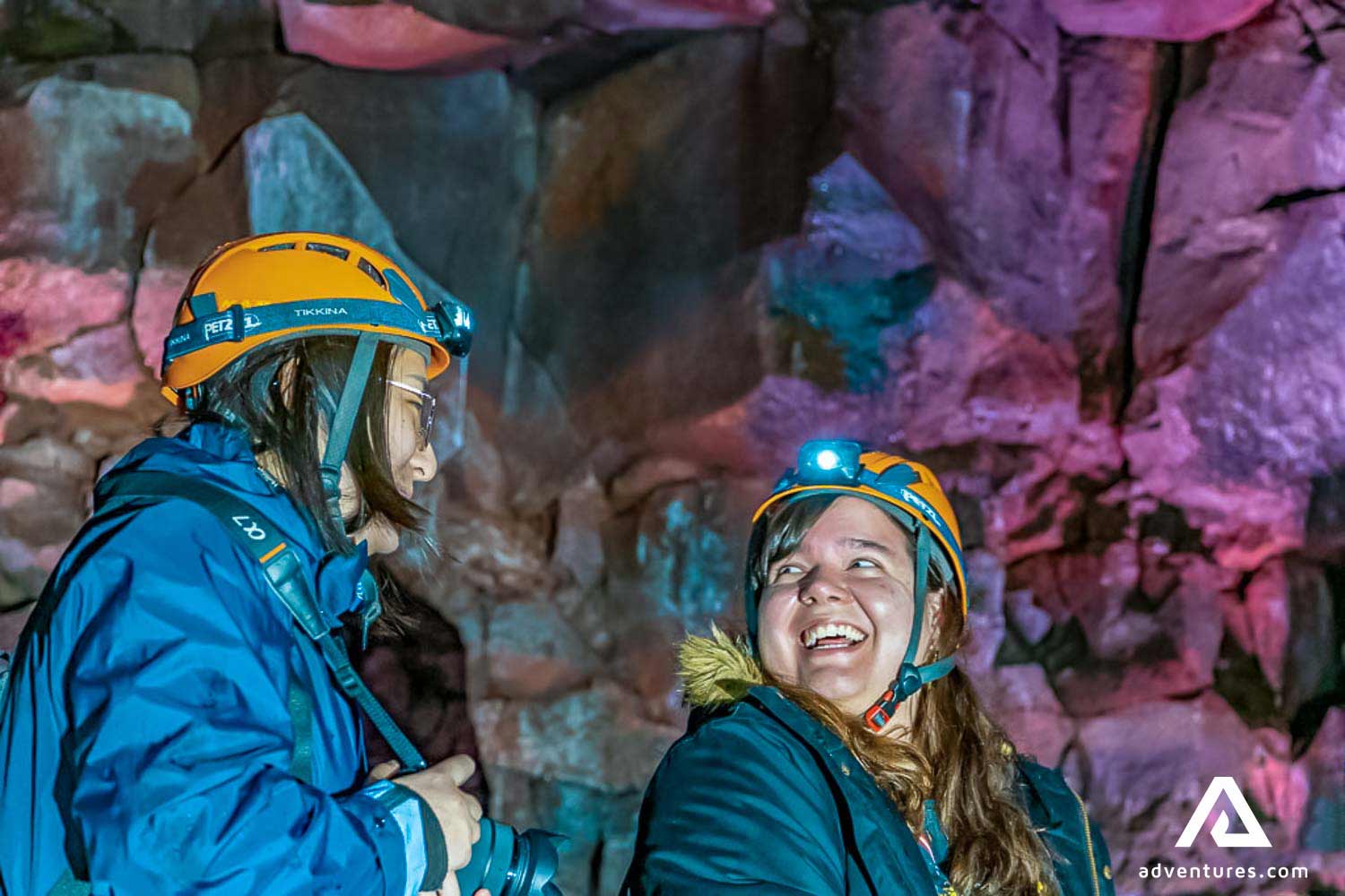 friends on a tour in a lava tube in iceland
