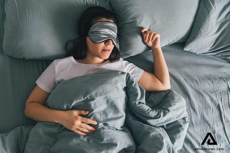 woman with a sleeping mask in bed