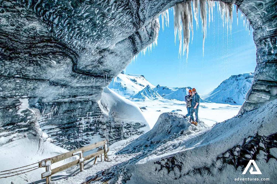 couple posing in katla ice cave in iceland