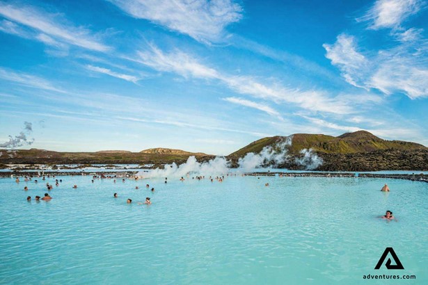 large group of people in the blue lagoon in iceland at summer