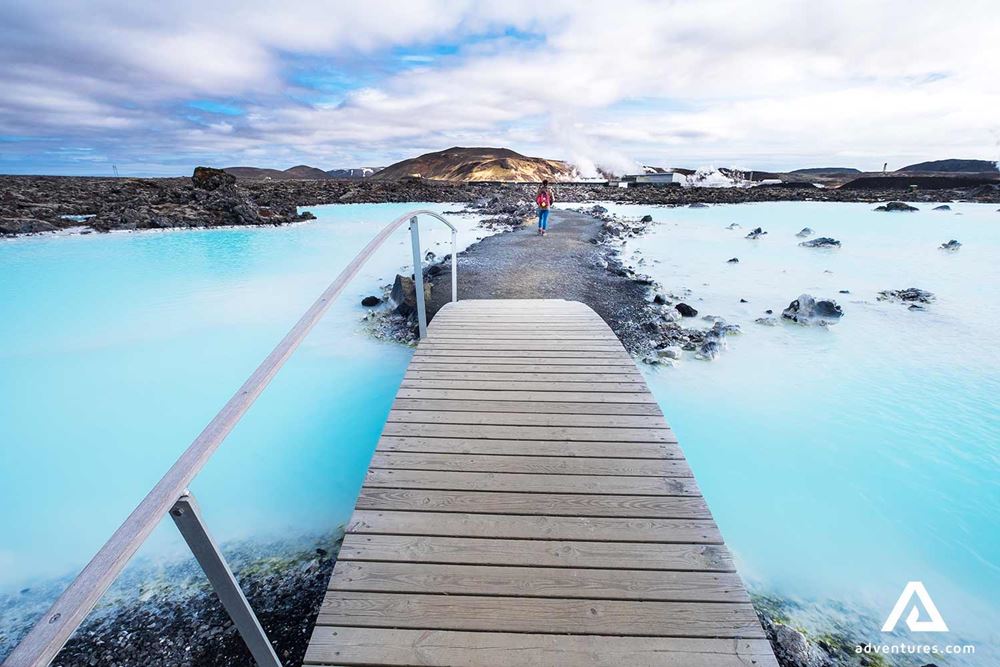 a wooden bridge leading to the blue lagoon